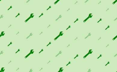 Seamless pattern of large and small green adjustable wrench symbols. The elements are arranged in a wavy. Vector illustration on light green background