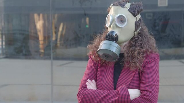 Woman with gas mask in a city. Nuclear apocalypse