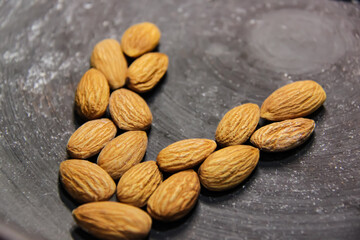 Almonds on dark surface