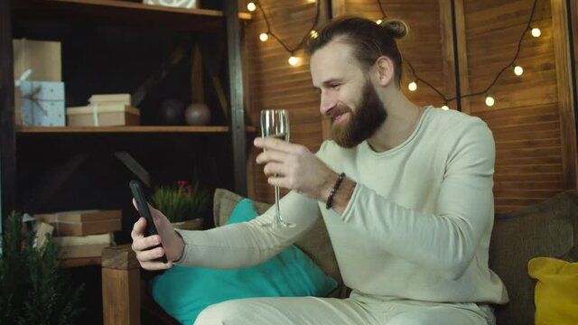 Young Casual handsome man Using Smartphone Drink vine. Talking online with friends, smiling and  toast with a full glass.