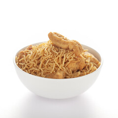 Indian spicy snacks (Namkeen) - Bikaneri Besan Bhujia in a white bowl, made with chickpea flour (Besan), side view, against the white background.