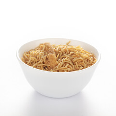Indian spicy snacks (Namkeen) - Bikaneri Besan Bhujia in a white bowl, made with chickpea flour (Besan), side view, against the white background.