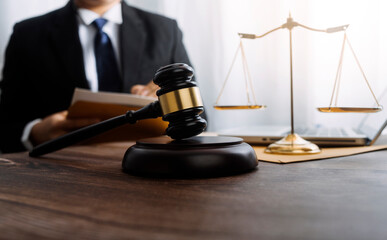 Business and lawyers discussing contract papers with brass scale on desk in office. Law, legal...