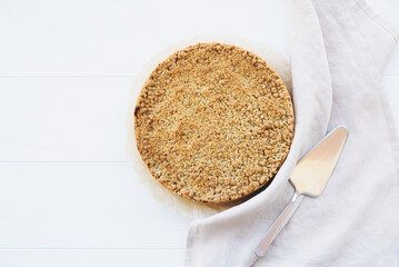 Freshly baked homemade double crutsed apple crumb pie on white background. Copy space. Sweet food.
