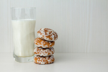 glass of milk and chocolate cookies on a wooden table