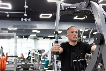 Man in the training gym  working hard after quarantine.