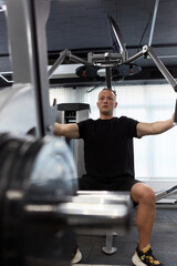 Man in the training gym  working hard after quarantine.