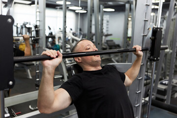 Man in the training gym  working hard after quarantine.