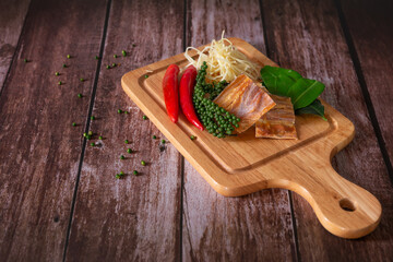 Spices with ingredients, Stir-Fried Spicy and herb with dried fish fillet on a cutting board with wooden dark background. Thai food concept.