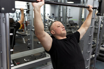 Man in the training gym  working hard after quarantine.