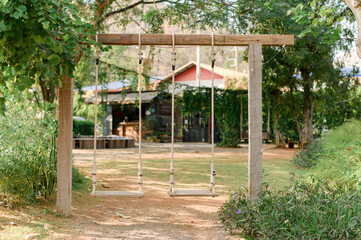Wooden swing in front of the house