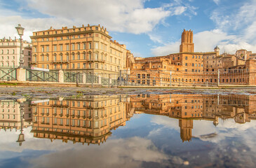 Fototapeta na wymiar Rome, Italy - in Winter time, frequent rain showers create pools in which the wonderful Old Town of Rome reflect like in a mirror. Here in particular Piazza Venezia