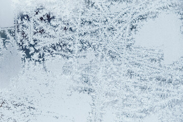 Ice patterns on frozen glass. Abstract ice pattern on winter glass as a background image. Copy, empty space for text