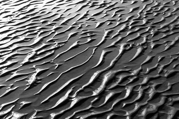 close up view of sand structures at low tide on a beach