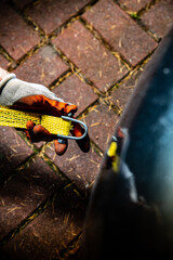 A male hand attaching a towline to a car towing eyelet.