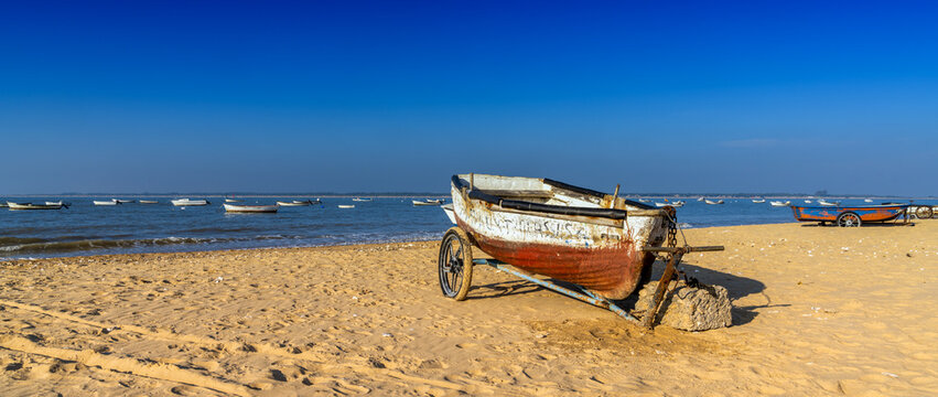old wooden fishing boats on the beach at Sanlucar de Barrameda