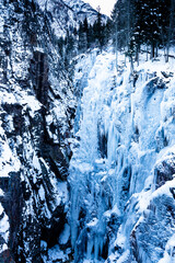 Fototapeta na wymiar Deep blue ice formations on a cliff face near Ouray, Colorado used for recreational ice climbing