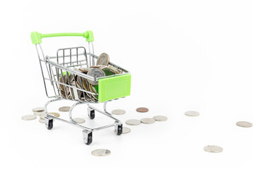 Mini silver shopping cart with coin in the cart on white background. Shopping concept.