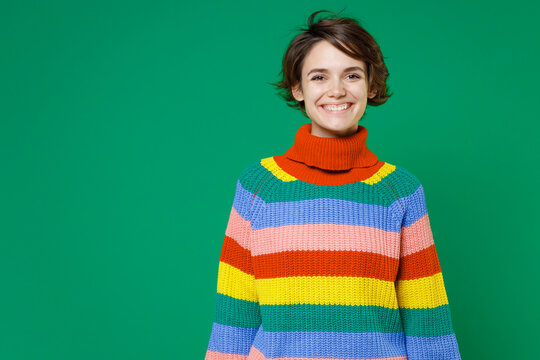 Smiling Cheerful Beautiful Attractive Young Brunette Woman 20s Years Old Wearing Basic Casual Colorful Sweater Standing And Looking Camera Isolated On Bright Green Color Background Studio Portrait.