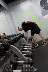 Man in the training gym  working hard after quarantine.