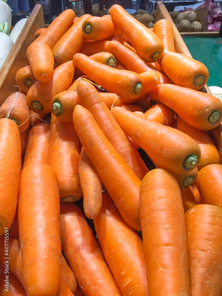 Wall mural jumbo pile of  large carrots background.