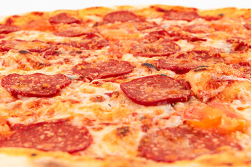 fresh aromatic hot italian pepperoni pizza with mozzarella cheese on white wooden table background