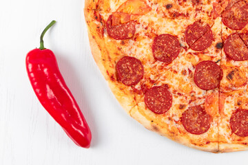 fresh aromatic hot pepperoni pizza with salami sausage and red pepper on white background
