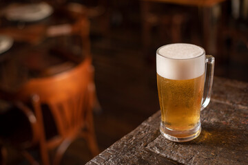 glass of beer on wooden table