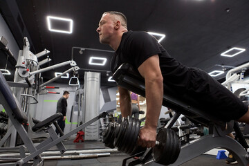Man in the training gym  working hard after quarantine.