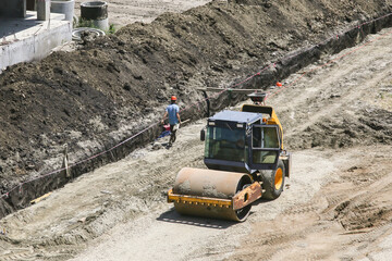 vibratory soil compactors at a construction site preparing the soil