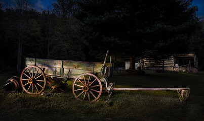 Fototapeta na wymiar Old horse-drawn wagon and log cabin in central Virginia.