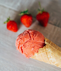 close up of strawberry icecream in waffle on table