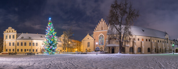 Winter in Krakow, Christmas Tree, Bishop's Palace and St Francis church in the snow, night, Poland