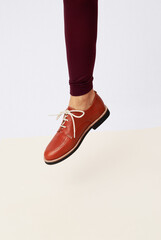 Shoot of unrecognizable woman leg wearing retro vintage brown shoes and leggins. Fashion vintage shop concept