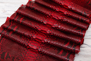 Red dyed genuine natural python leather with a black snake print.