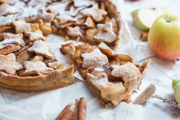 Traditional apple pie on the table with decorations.