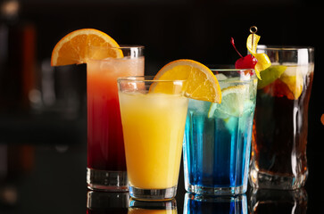 Different delicious cocktails on counter in bar