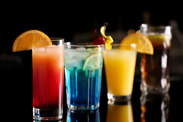 Different delicious cocktails on counter in bar