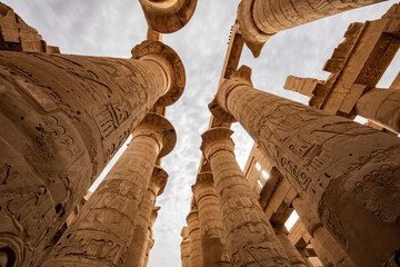 Karnak Temple Complex in Luxor Egypt. Central columns  of the Hypostyle Hall with hieroglyphics.