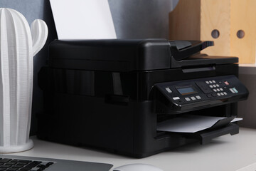 Modern printer and decor element on white table