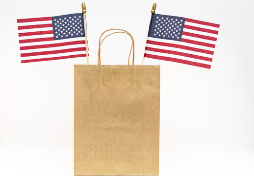 American flags in a brown paper bag for advertisement of sales.