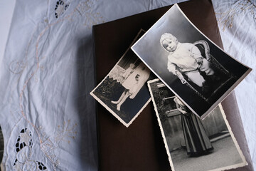 old photo albums lie on a white mint tablecloth, vintage photographs of 1960, concept of family tree, genealogy, childhood memories, connection with ancestors