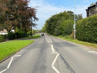 View of, Bradford Road, with trees and houses, leading toward, Otley, Yorkshire, UK