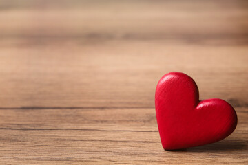 Fototapeta premium Red decorative heart on wooden table, space for text. Valentine's Day