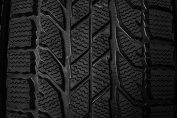 Winter tire as background, closeup. Car maintenance