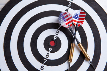 dart arrow hitting in the target center of dartboard.