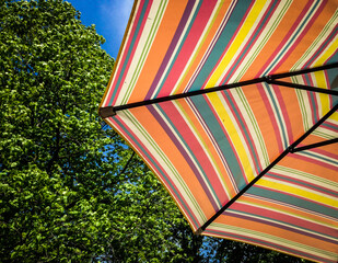 looking up at colorful patio umbrella