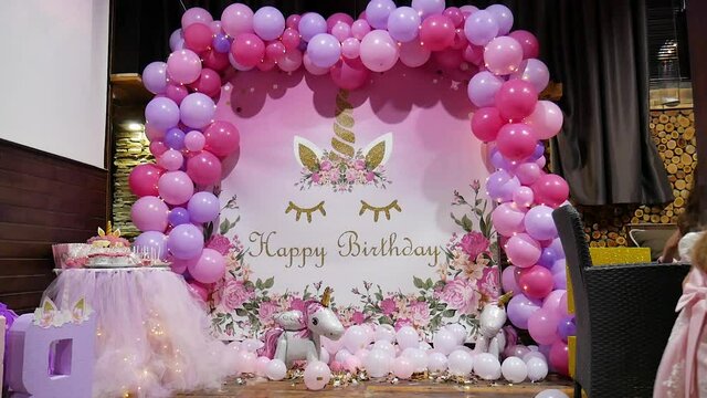 Ideas for the holiday. Birthday unicorn-style photo zone decorated with pink, red and purple balloons
