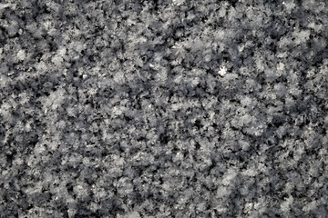 White ice patterns close up on a black background
