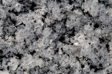 White ice patterns close up on a black background